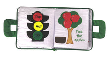 Children's book with traffic light and apple tree illustrations on a white background